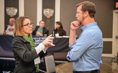 Maryland Department of the Environment Assistant Secretary Suzanne Dorsey, PhD, engages in a discussion with a conference attendee.