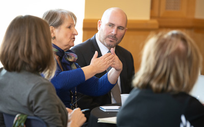 M.J. Tooey, MLS, AHIP, FMLA, associate VP/executive director, HS/HSL, asks a question during a panel discussion with European Union ambassadors. 