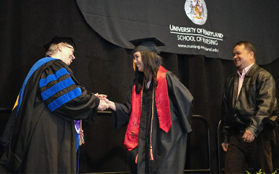 Rebecca Wiseman, PhD, RN, chair, UMSON program at the Universities at Shady Grove, congratulates a nursing graduate. 