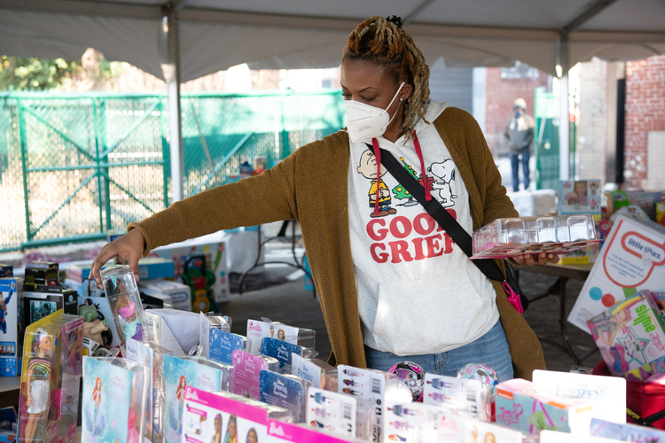 Demeter, a West Baltimore community member, picks out the perfect dolls to give to her two daughters for Christmas.