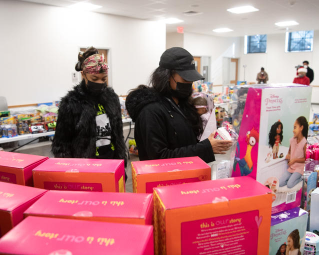West Baltimore neighbors browse the toy selection at the annual Christmas Store, set up by Foundry Church and UMB's Community Engagement Center.
