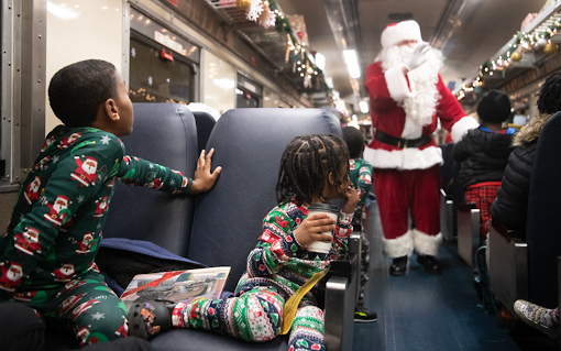 Santa Claus boards the train to greet the children taking part in the Polar Express Experience at the B&O Railroad Museum.