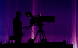 Image of person behind large television camera
