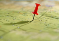a red pushpin marking a place on a map