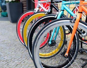 Four bikes varying in color lined up in a row