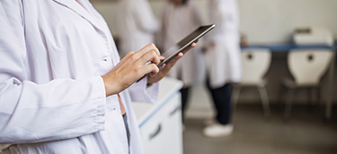 Women in a white coat on a phone