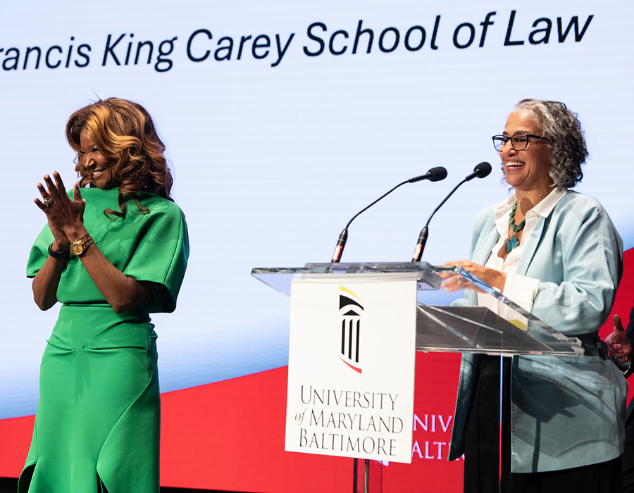 Dean Hutchins Laurent and Tamika Tremaglio on stage at the Celebrating Excellence event.