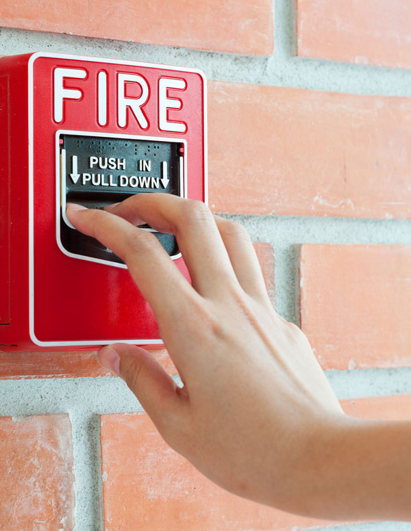Person pulling a fire alarm