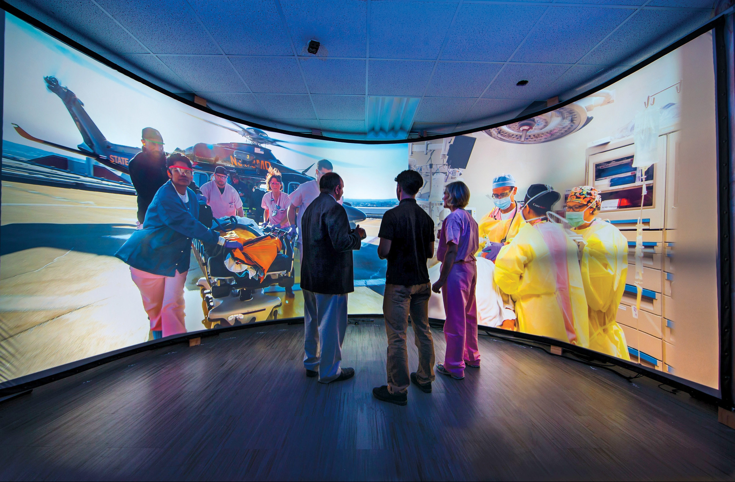three people watch life size screens to give support to onsite personnel