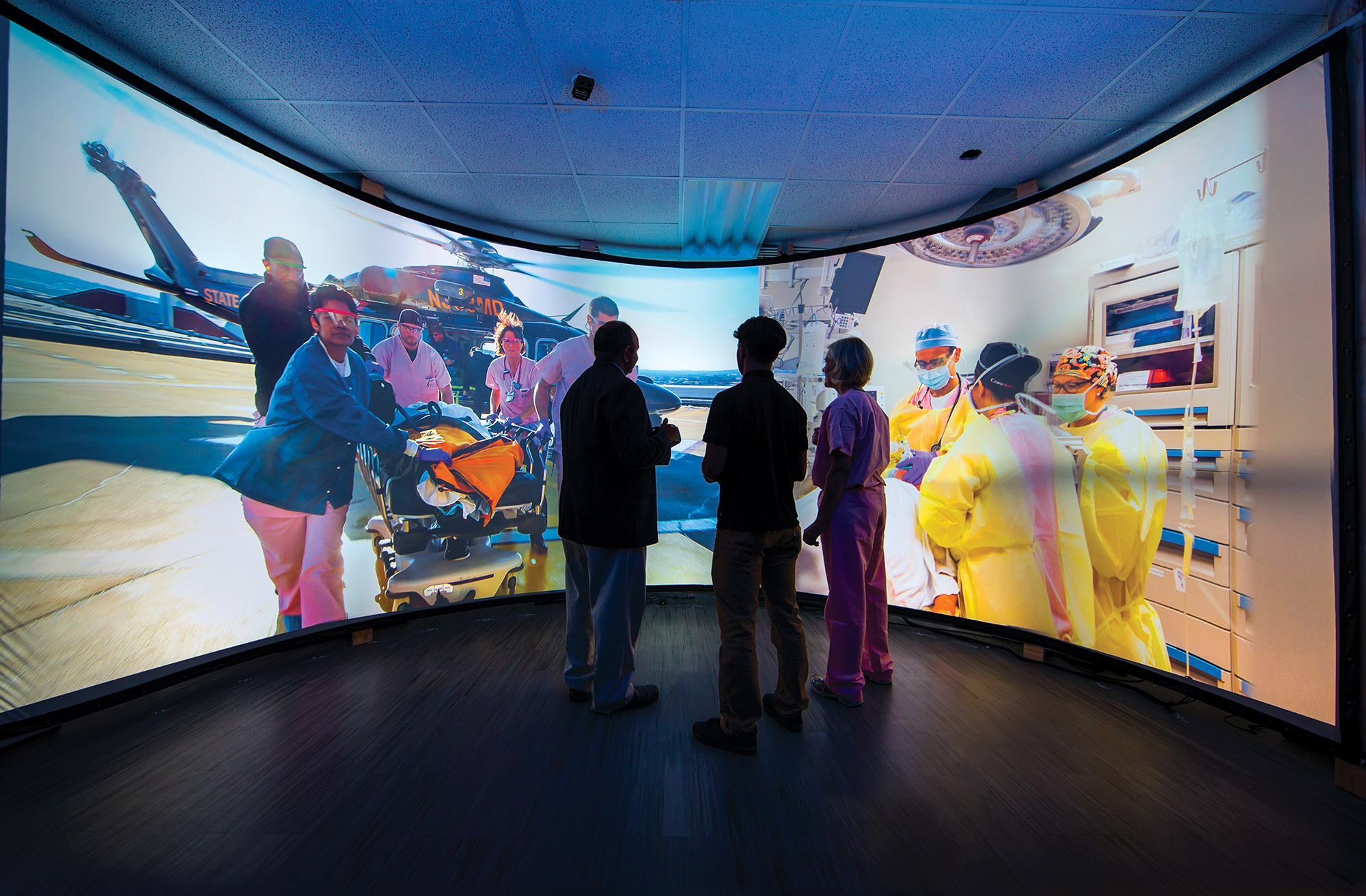 three people watch life size screens to give support to onsite personnel