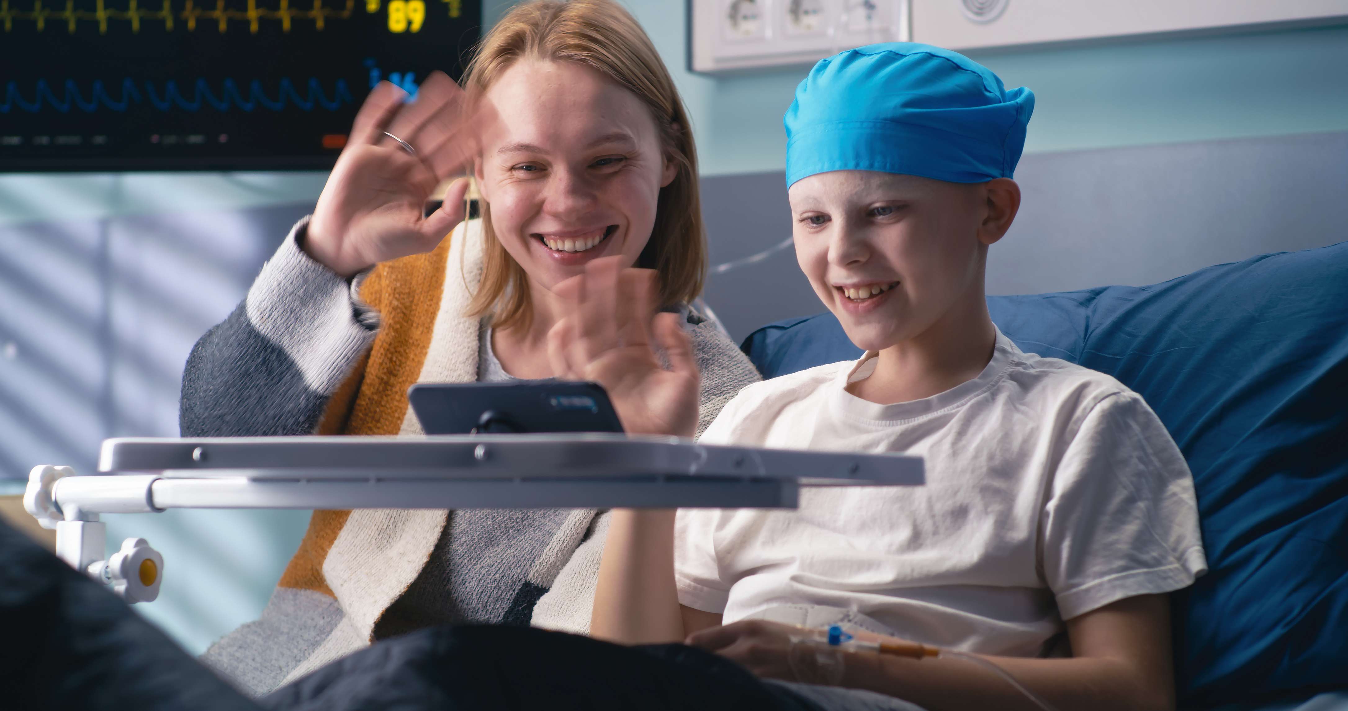 A seriously ill child patient and their sibling together in a hospital.