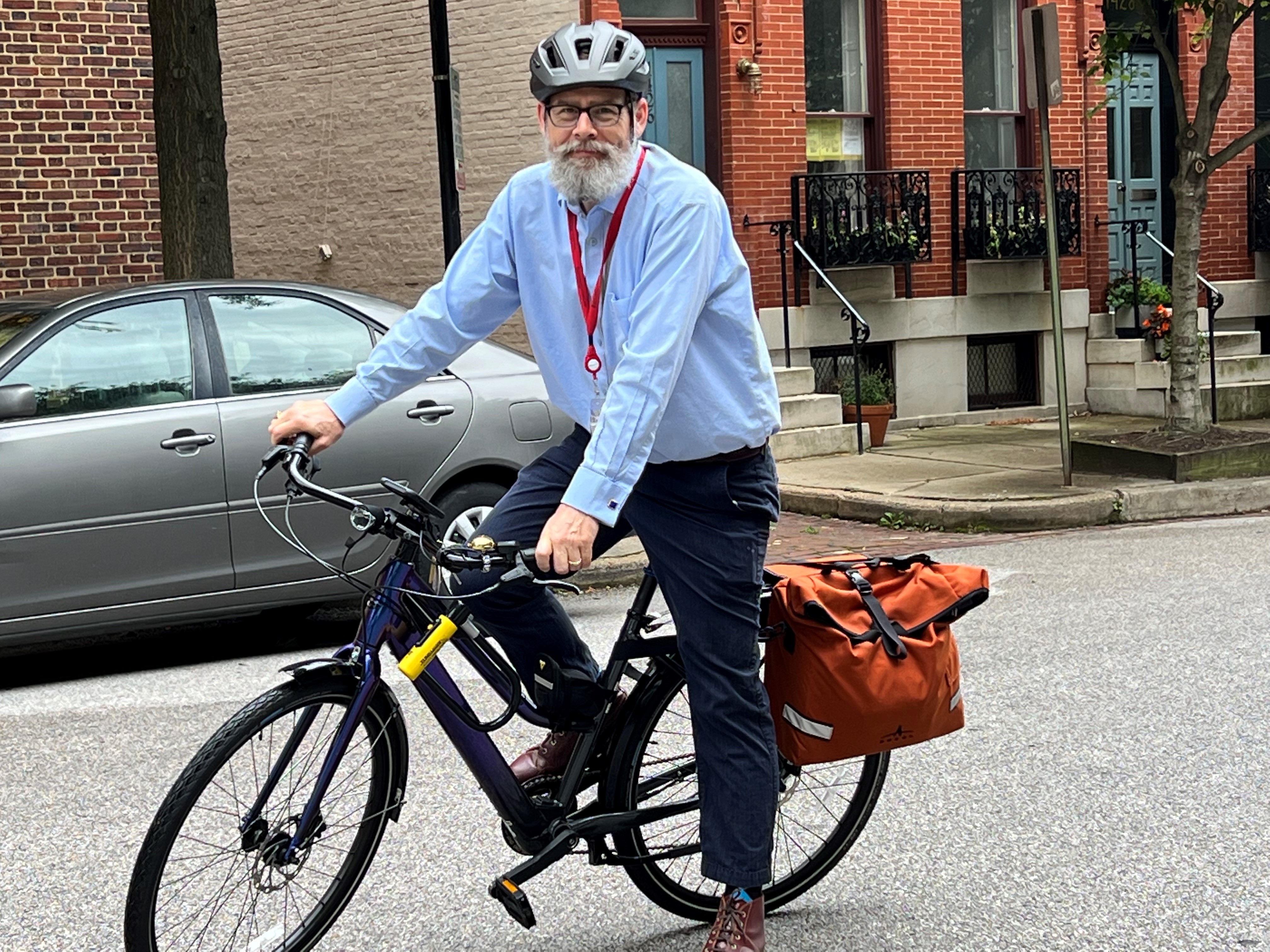 staff member riding his bike