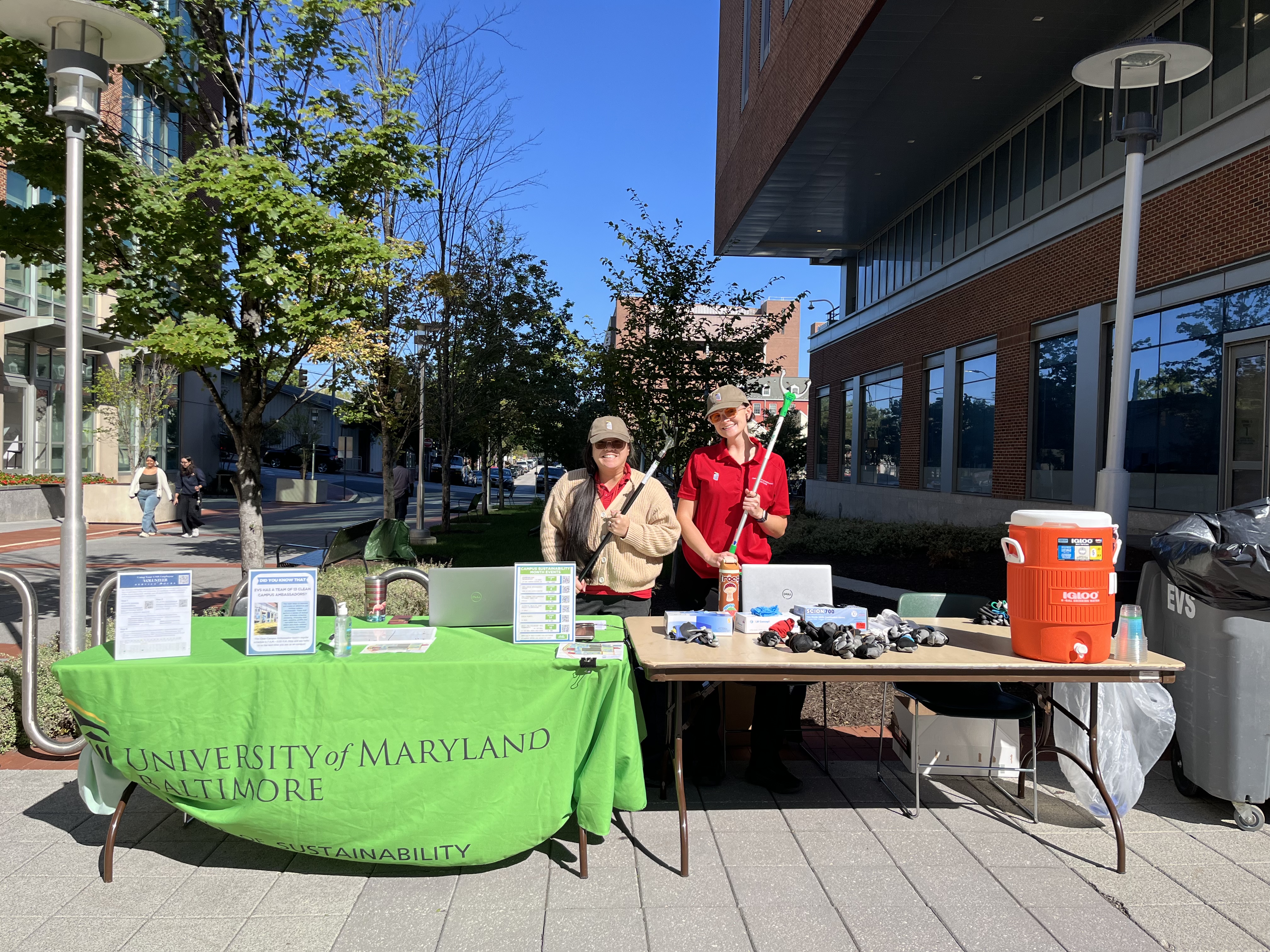 two staff members at campus cleanup table
