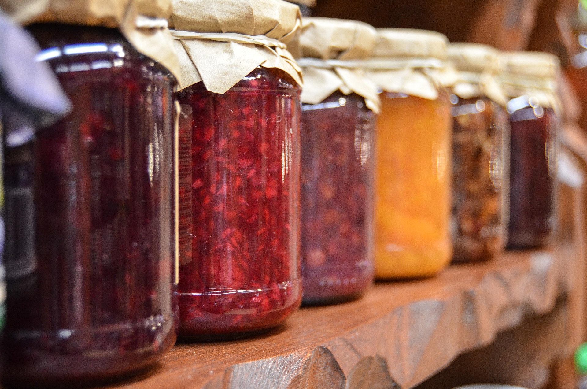 Six jars of different types of jams (the condiment)