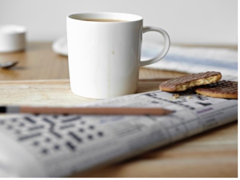 photo of a cup and a crossword puzzle